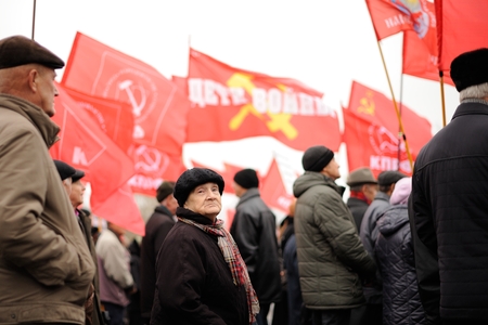 Orel, Russia - November 07, 2016: Communist meeting. Senior people in black with red Soviet banners selective focusのeditorial素材