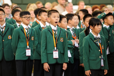 Orel, Russia - August 04, 2016: Brass bands fest. Choir of Chinese children in green uniformのeditorial素材