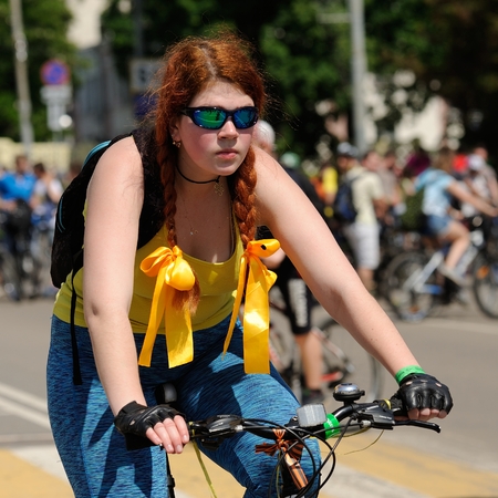 Orel, Russia - May 29, 2016: Russian Bikeday in Orel. Redhead girl in sunglasses riding bicycle closeupのeditorial素材
