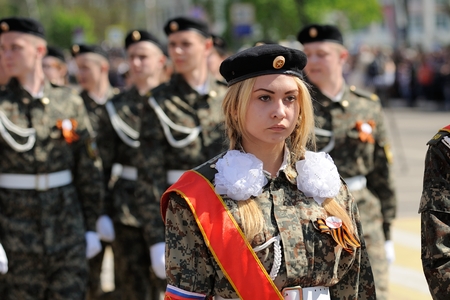 Orel, Russia - May 9, 2016: Celebration of 71th anniversary of the Victory Day (WWII). Young blond girl military marchingのeditorial素材