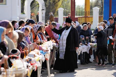 Orel, Russia - April 30, 2016: Paschal blessing of Easter baskets in Orthodox church.  Priest...