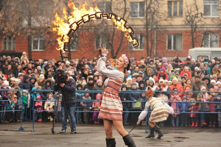 Orel, Russia - March 13, 2016: Maslenitsa, Pancake festival. Fire dancer in Russian clothes performing for crowd horizontalのeditorial素材
