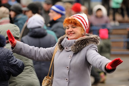 Orel, Russia - March 13, 2016: Maslenitsa, Pancake festival. Woman dancing in the street selective focusのeditorial素材