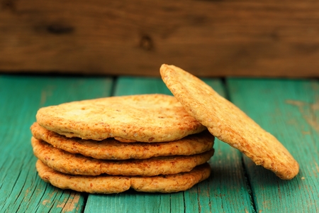 Yummy homemade almond cookies in pile on turquoise shabby background copyspace horizontalの写真素材