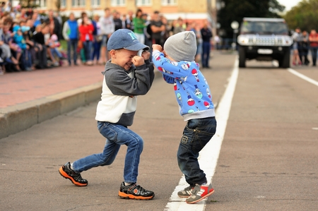 Orel, Russia, September 5, 2015: Two little boys fighting in empty road horizontalのeditorial素材