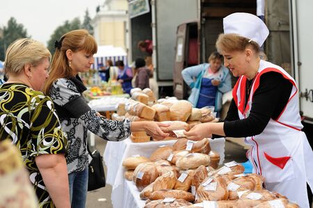 Orel, Russia, September 5, 2015: Women selling and buying pastry in autumn fair horizontalのeditorial素材