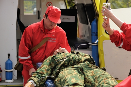 Orel, Russia - August 28, 2015: Russian Emergency Control first aid training putting IV on injured...