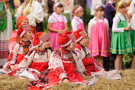 Orel, Russia - June 19, 2015: Orlovskaya Mozaika music fest: young girls in pink dress sitting and standing horizontalのeditorial素材