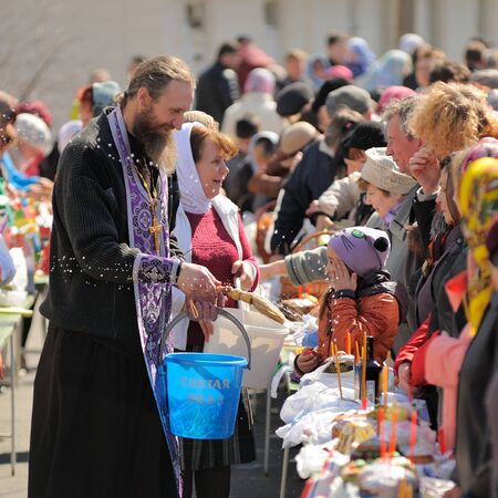 Orel, Russia, April 11, 2015: Traditional orthodox paschal ritual - priest blessing easter eggs and...