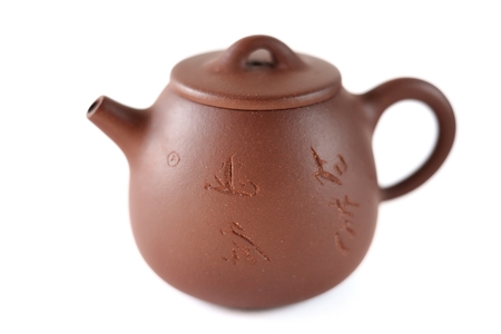 Chinese Yixing clay tea pot with insription: Zhou Ting Shou Zhi isolatedの写真素材