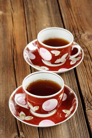 Two cups of black tea with wooden background verticalの写真素材