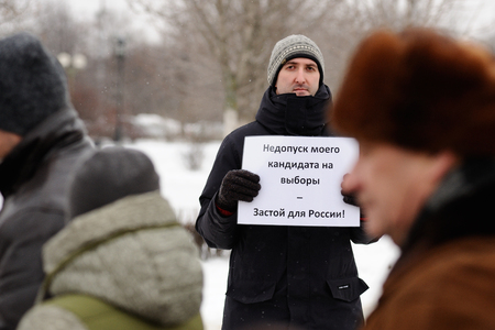 Orel, Russia, January 28, 2018: Election protest supporting Alexey Navalny. Young picketer with banner selective focusのeditorial素材