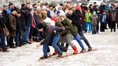 Orel, Russia, February 18, 2018: Maslenitsa carnival. People playing in snowy square together