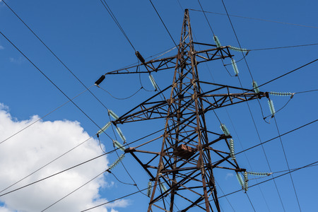 High voltage power line against blue sky and little  cloud in sunny day