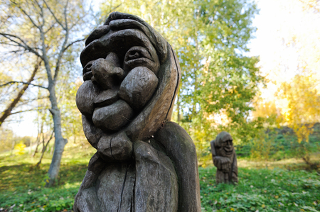 Russian vintage wood carving. Shabby wooden sculpture of old woman closeupの写真素材