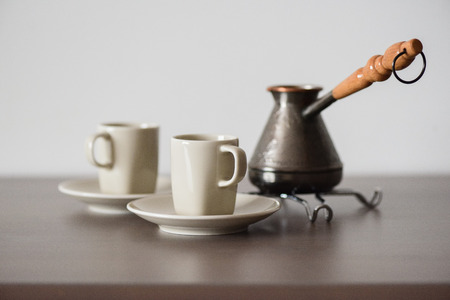 Traditional Turkish coffee brewed in coffee pot minimalist style copyspaceの写真素材