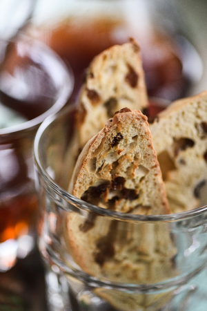 Close up of homemade traditional Italian biscotti or cantucci with raisins in glass served with coffee closeupの写真素材
