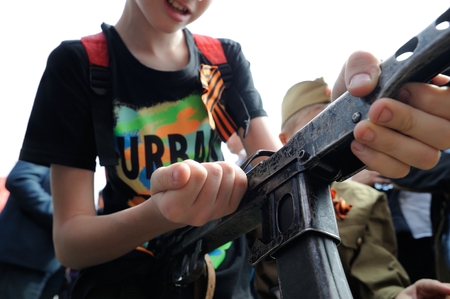 Orel, Russia, May 09, 2019: Victory Day, Immortal Regiment parade. Boy with automatic weapon closeupのeditorial素材