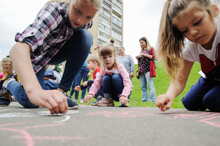 Orel, Russia, May 26, 2019: Twin Festival. Children drawing with chalk on asphalt sloceupのeditorial素材