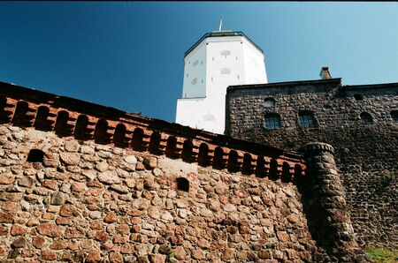 Medieval architecture. Ancient stone wall, fortress and tower in Vyborg, Russia, side view copy...