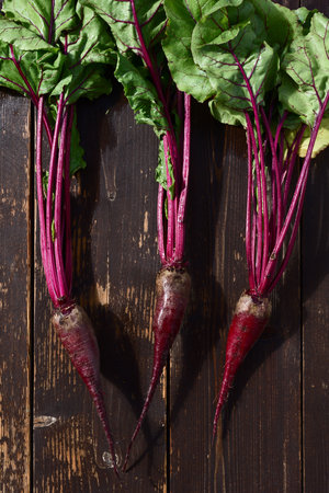 Beetroot with tops on a wooden background overhead viewの写真素材