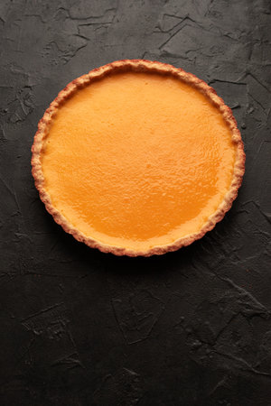 Pumpkin pie on dark background overhead viewの写真素材