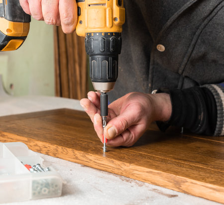 The carpenter tightens the screws close up closeupの写真素材