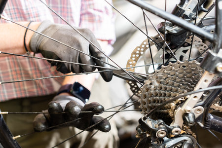 The bike master corrects the brake disc close up