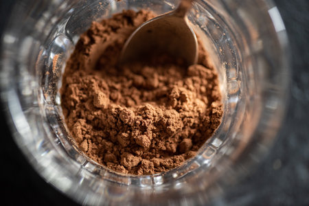 Cocoa powder in a Irish glass overhead view closeup