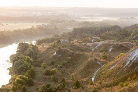 Sunrise over the river, hills and paths landscapeの写真素材