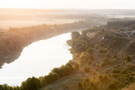 The river in the rays of the rising sun landscape
