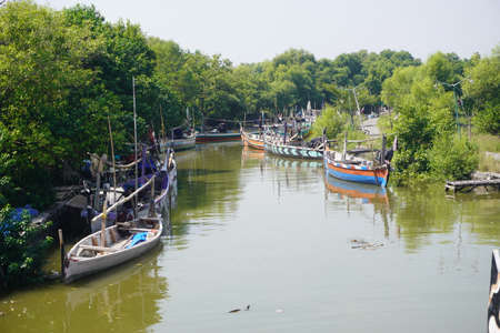 Traditional fishing boat that made from wood are docked at outfallの写真素材