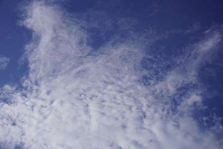 Blue sky with dense white clouds on a sunny dayの写真素材