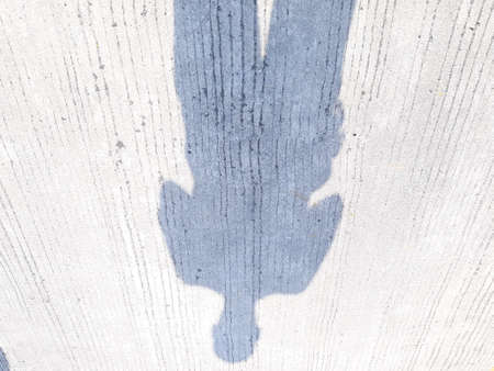 Shadow of a person on a concrete wall. Abstract background.の写真素材