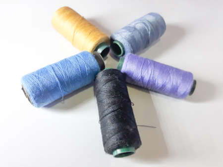 Spools of thread on a white background. Sewing accessories.