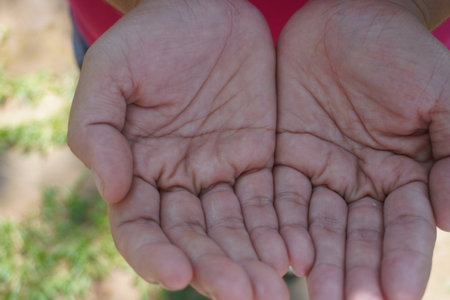 Close up of female hands holding each other with love and care.の写真素材