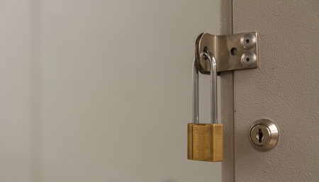 Padlock locks locker on the empty blur background.の写真素材