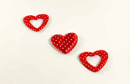 The red hearts on the white background.