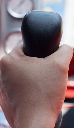 Soft focus gearbox is holded by hand someone.の写真素材