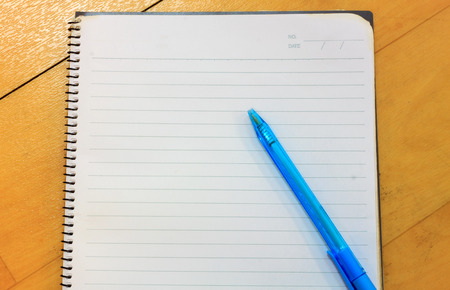 pen,notebook on wood background.の写真素材