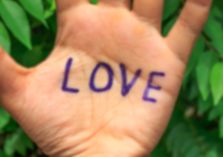 Design blur word love on hand , tree background.の写真素材