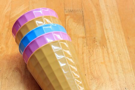 Colorful plastic glasses on wood background.の写真素材