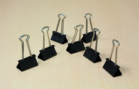 Paper clip on the wood background.の写真素材