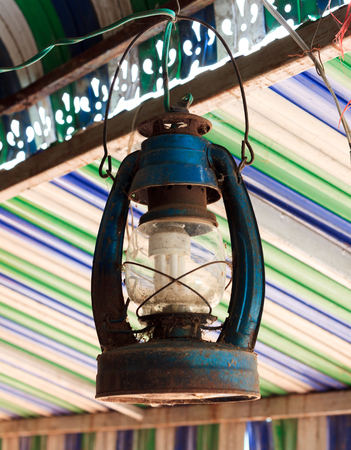 The old lamp hangs on beam colorful blur background.の写真素材