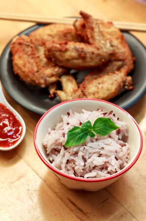 Meal set the rice blur sauce and chicken on the wood background.の写真素材