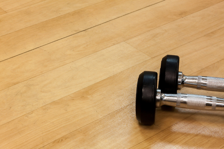 Dumbbells on the wood background.の写真素材