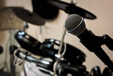 Microphone on blur drum background and vignetting.