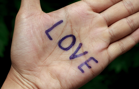 text love on hand and blur tree background.の写真素材