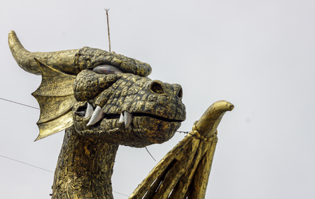 Head of metal sculpture dragon and blur background.の写真素材