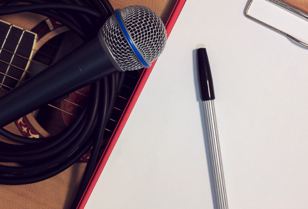 Pen,paper microphone on guitar background.の写真素材